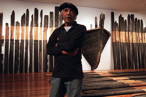 Ralph Hotere with his installation Black Phoenix. Photo / Otago Daily Times