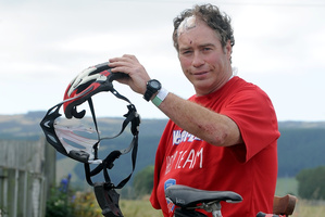 John Nicholl with what is left of his helmet and his damaged bicycle. Photo / Supplied