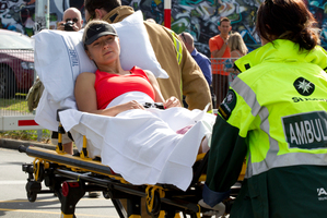 The injured jogger who helped rescue the wheelchair-bound woman is taken to hospital. Photo / Brett Phibbs