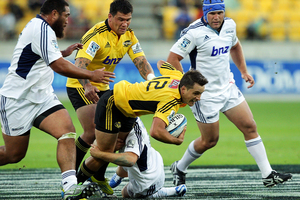 Tim Bateman of the Hurricanes is tackled during his side's defeat to the Blues. Photo / Getty Images