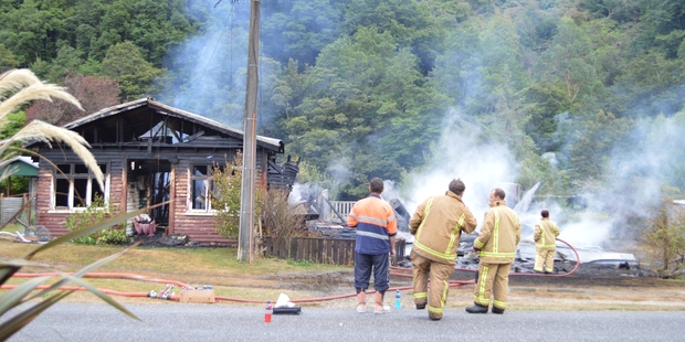 Two Blacks Point houses were destroyed by fire early this morning, with the house on the right completely razed. Photo / Greymouth Star