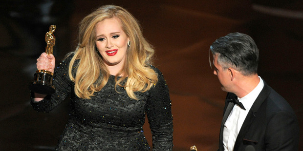 Adele with her Oscar for best original song. Photo/AP