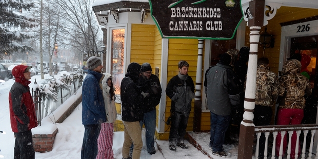 Smokers queue outside the Cannabis Club in downtown Breckenridge waiting for the 8am opening. Photo / AP