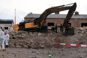 Police forces examine the scene of a World War II bomb explosion during construction works of a digger in Euskirchen, Germany. Photo / AP