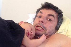 Marcus Lush hams it up in a selfie with newborn son Tracker. Photo / Twitter