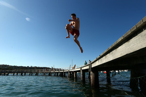 A man jumps into the water at Balmoral Beach, Sydney to cool off during a record hot day in October. Photo / Getty