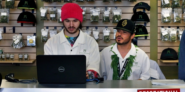 Employees Chris Broussard and David Marlow work inside Medicine Man marijuana store. Photo / AP