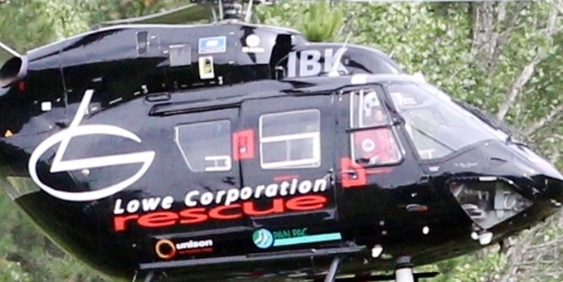 AIR RESCUE: The Lowe Corporation rescue helicopter winches a victim to safety, after a crash on State Highway 5 near Te Haroto. Eight people with various injuries were taken to hospitals in Hawke's Bay and Rotorua. PHOTO/PAUL TAYLOR HBT140355-06