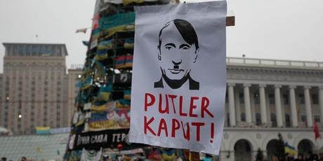 A poster with the caricature of Vladimir Putin is carried at a rally in Kiev's Independence Square. Photo / AP