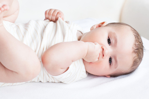Portrait of a cute newborn baby lying on the sofa in his bedroom