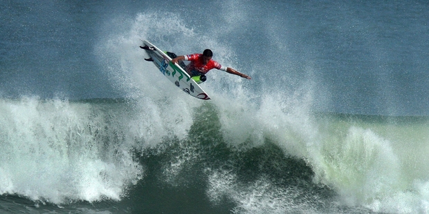 New Zealand surfer Richard Christie blasts off the top of a wave at Waikanae Beach in Gisborne during the O'Neill Coldwater Classic surf contest.