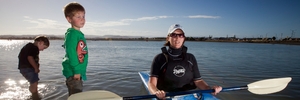 GO MUM! Lukas and Bastian Inger might have had other things on their minds as they paddled in the shallow waters of Pandora Pond at low tide last night, but it was clear who they're backing in the Tremains Corporate Triathlon tomorrow - mum and Napier City Council team kayaker Libby Inger.PHOTO/GLENN TAYLOR HBT140777-02