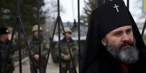 Ukrainian Orthodox Archbishop Clement stands guarding a gate of a Ukrainian military base in the village of Perevalne, outside of Simferopol yesterday. Photo / AP