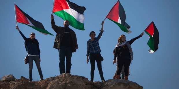 Demonstrators wave Palestinian flags during a protest against the expansion of the Maaleh Adumim settlement. Photo / AP