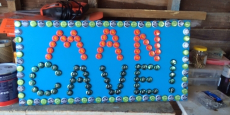 A reader writes: "My brother entered into a competition at Mitre 10 Mega to win a 'man cave surprise'. Well he sure was surprised when he found the prize was a homemade beer bottle top sign!''
