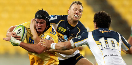 Adam Hill of the Hurricanes is tackled by Jesse Mogg of the Brumbies. Photo / Getty Images