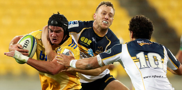 Adam Hill of the Hurricanes is tackled by Jesse Mogg of the Brumbies. Photo / Getty Images