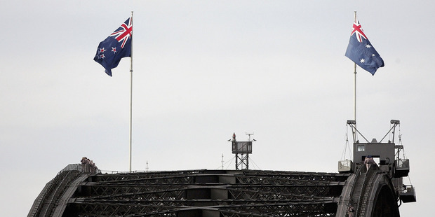 Partnership: The New Zealand flag, left, alongside Australia's on Anzac day. Australia and New Zealand may have to work together to make the most of what we both have. Photo / Getty Images