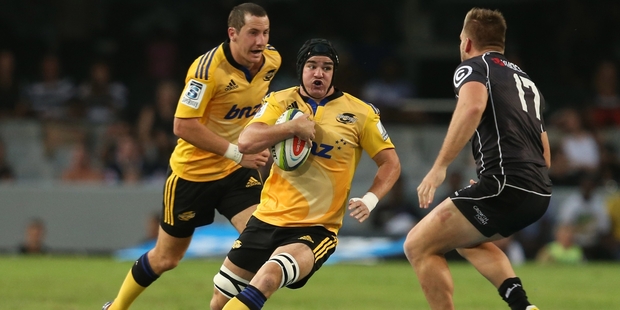 Hurricanes loosie Adam Hill, center, enjoys the rough and tumble. Photo / Getty Images