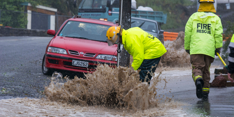 Firefighters check storm water flooding on Voelas Road, Lyttelton, Christchurch. Photo / SNPA / David Alexander