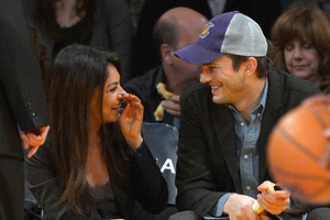 Mila Kunis and Ashton Kutcher are expecting their first child together, reports say. Photo/AP