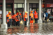 City council workers sand bag shops in Shirley, Christchurch. Photo / Getty Images