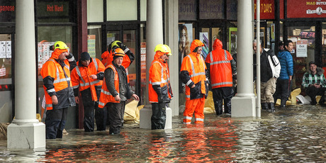 City council workers sand bag shops in Shirley, Christchurch. Photo / Getty Images