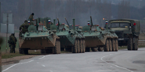 Russian armoured personnel carriers and a truck are parked on the side of the road near the town of Bakhchisarai, Ukraine. Photo / AP