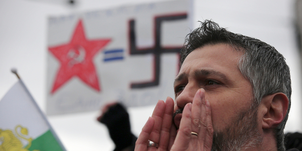 Bulgarian protesters shout anti-Russian slogans during a protest in front of the Russian embassy in Sofia. Photo / AP