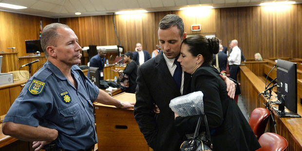 Oscar Pistorius, hugs his sister Aimee, right, inside court at the end of the second day of his trial. Photo / AP