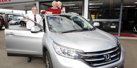 Norm and Barb Wilkinson with Honda's Neil Dunn and the new car they ended up paying nothing for. Photo/Paul Taylor