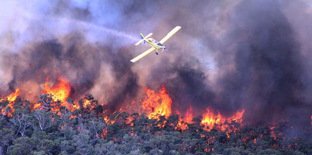 A water bomber works over a large fire burning throughout Victoria's Grampians region. Photo / AP