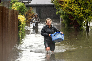 Residents in Shirley move their belongings out of their flooded homes in Christchurch, New Zealand. Photo / Martin Hunter