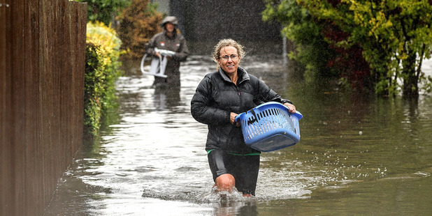 Residents in Shirley move their belongings out of their flooded homes in Christchurch, New Zealand. Photo / Martin Hunter