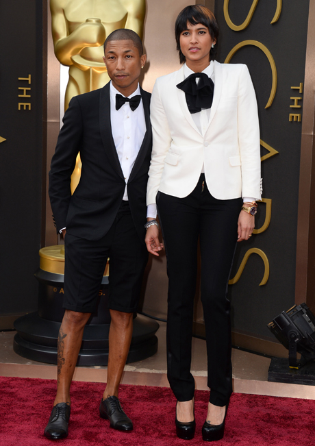 Pharrell Williams, left, and his wife Helen Lasichanh arrive on the Oscars red carpet. Photo / AP