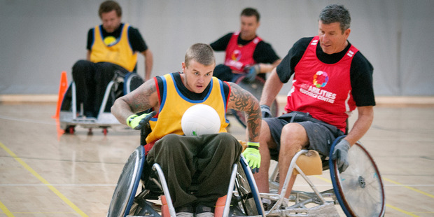 Scott MacDonald, chased by Lester Phelps, speeds away with the ball in the second division wheelchair rugby champs at the weekend.