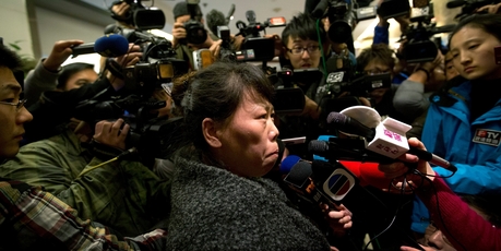 A Chinese relative of passengers aboard the missing Flight MH370 talks to the media. Photo / AP