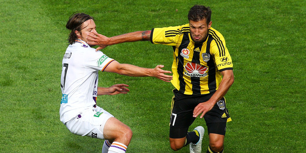 Vince Lia of the Phoenix beats the defence of Chris Harold of the Glory during the round 22 A-League match between Wellington Phoenix and Perth Glory. Photo / Getty Images.