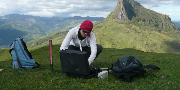 Caroline Little can be found going through earthquake data in the office or setting up seismic equipment, like here on Mt Hikurangi on the East Coast. Photo / GNS Science
