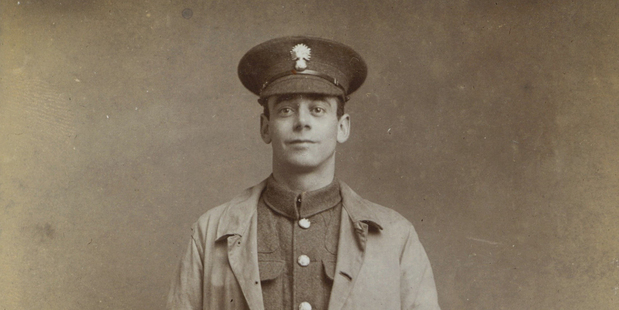 A soldier from the Grenadier Guards wearing a trench coat that became standard issue for memberso fthe British Army in World War I.