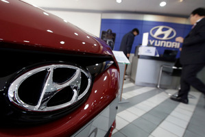 The logo of Hyundai Motor Co. is seen on a car at the automaker's showroom in Seoul, South Korea, Hybrid cars from the Korean manufacturer are boosting car sales. Photo / AP