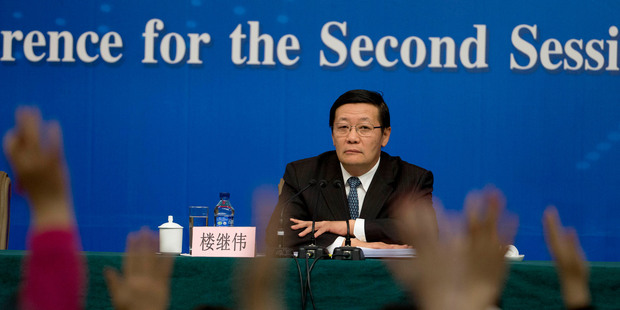 In a key speech Finance Minister Lou Jiwei announced the economic growth target will stay at 7.5 per cent this year. Photo / AP