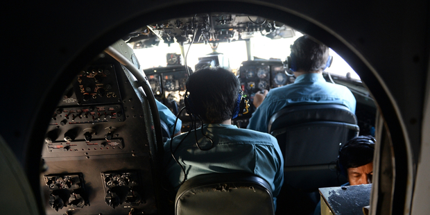 Vietnamese air force crew manage a plane during a search and rescue operation for the aircraft. Photo / AP