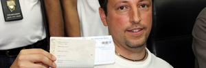 Italian Luigi Maraldi, whose stolen passport was used by a passenger boarding a missing Malaysian airliner, shows his passport as he reports himself to Thai police at Phuket police station. Photo / AP