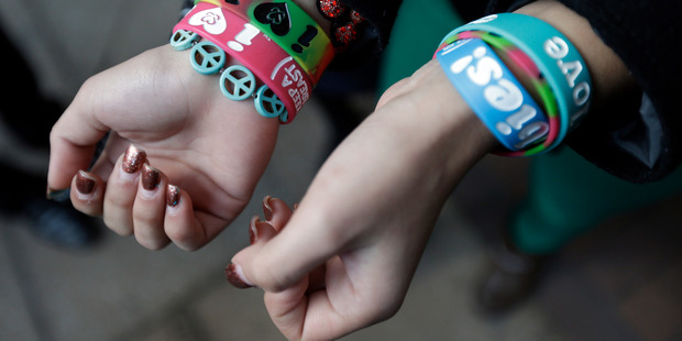 Easton Area School District student Kayla Martinez, 14, displays her bracelets for photographers outside the US Courthouse in Philadelphia. Photo / AP