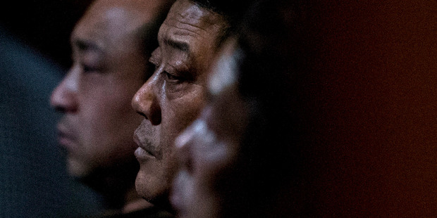 Relatives of Chinese passengers aboard missing Malaysia Airlines Flight MH370 watch a TV news program about the missing flight. Photo / AP