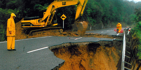 1996 file photo - Workers inspect the remains of the section of State Highway 1 on the Brynderwyn Hills that was closed after a slip following Cyclone Fergus. Photo / NZ Herald
