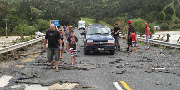 Motorists stranded just north of Kawakawa survey the damage to SH11 after ex-tropical cyclone Wilma battered the Far North, January 29, 2011. Photo / NZ Herald