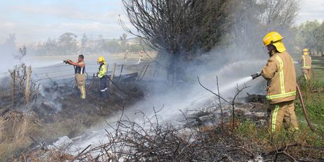 Fire crews from Martinborough, Carterton and Featherston damp down a scrub fire on the boundary of Brackenridge Resort and Spa on White Rock Rd near Martinborough, while a wedding was taking place.
