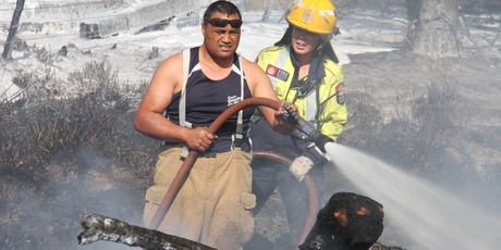 Surrounded by foam and smoke, Carterton fireman Swanny Nicho damps down a tree fire in Martinborough, near the Brackenridge Country Retreat and Spa.
